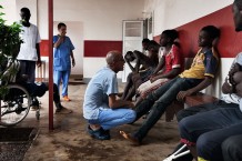 Surgical Centre, triage of a group of injured boys and a girl just arrived. Goderich, Freetown, Sierra Leone 2017