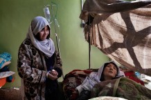 This family traveled from Khost to Kabul a journey of seven days to save her mother. In Kabul the hospital administrators refused to admit them, because their municipal hospital is in Herat, in the west of the country. They embarked on a ten day journey, after having sold all their farm animals. The day they arrived in Herat, they had no more money to feed themselves. The concerned daughter embroidered fabrics hoping to sell them in the market. We purchased her handicraft so that they had enough money for food the week.<br>TB Centre, hospital. Herat, 2012