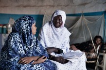 Trained midwife Aisha Salih Dawod Omer, 41 years old, visiting Manahel Abdalrahman, 20 years old, going to deliver her second child at home. On the background her sister Manhel, 25 years old, who delivered 35 days ago. According to tradition, Sudanese women rest for 40 days after delivering. Um Khanger Almadrsa, Gedaref State, Sudan 2015