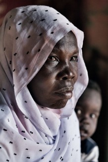 Trained midwife Aisha Salih Dawod Omer, 41 years old, at her home with her grandson. Um Khanger Almadrsa, Gedaref State, Sudan 2015