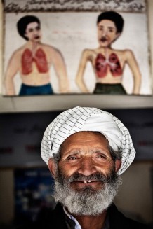 Gul Ahmad is the guard at the Herat Tuberculosis clinic. He reassured us that he knows when an Afghan is a Tuberculosis positive before the sputum exam and X rays. He can recognize a patient from far away trying to disguise their coughing, sweating and weakness. On average he sees 15-20 patients every day. Half of them end up going home with anti-TB drugs.<br>TB Centre, OPD (outpatient department). Herat, 2012