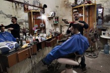 A barbershop at Tebenneh, stronghold of Sunni Muslims. Destruction and poverty are consequences of recurring fightings with Alawites of Jabal Mohsen or with the Libanese army.Tripoli, Lebanon, 2014