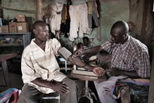 Community health worker Anas Rabih Babiker, 26 years old, measuring the pressure of Abasmusa, 25 years old, at Gargosha, Rahad. Gedaref State, Sudan 2015