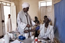 Health worker Mohammad Taha Onour, 60 years old, measuring the blood pressure of Shaiga Abu Fatima, 65 years old. Tahaday Oasis health unit, Kassala State. Sudan 2015