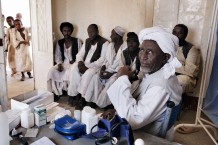 Health worker Mohammad Taha Onour, 60 years old, and his patients at Tahaday Oasis health unit. Kassala State, Sudan 2015