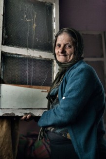 Badiah, who doesn't know her age. The walls in her house are full of holes of bullets, but luckily nobody was injured. Jabal (Mountain) Mohsen, stronghold of Alawite Muslims. Tripoli, Lebanon 2014