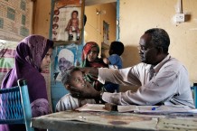 Medical assistant Ahmed Hassan Ahmed, 51 years old, visiting Osman Hamed, 4 years old. Osman cut his eye with a thorn of a tree, and is fortunately not seriously injured. Ardalhager health centre, Girba locality, Kassala State. Sudan 2015