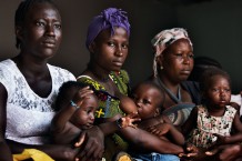 Paediatric Centre, where 150 children are visited every day, triage area. From left: Sama, 19 years old, with her son Kariati, 6 months, Fatmata, 20 years old, with her son Henry, 1 year and 9 months, Aminata, 45 years old, with her granddaughter of the same name, 1 year and 6 months. Goderich, Freetown, Sierra Leone 2017