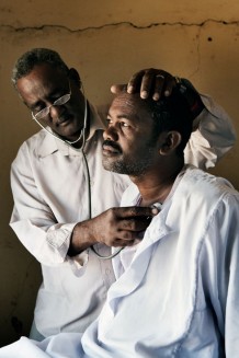 Medical assistant Ahmed Hassan Ahmed, 51 years old, visiting Gmal Mohamed, 35 years old, suffering of chest inflammation. Ardalhager health centre, Girba locality, Kassala State. Sudan 2015
