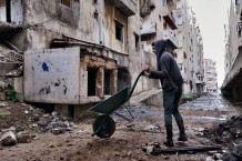 On a frontline between Tebenneh (left), stronghold of Sunni Muslims, and Jabal (Mountain) Mohsen (right), stronghold of Alawite Muslims. ICRC's cash for work project: men are cleaning the area, while others will fix its sewage. Tripoli, Lebanon, 2014