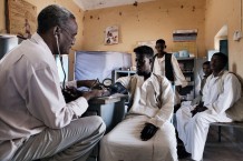 Medical assistant Ahmed Hassan Ahmed, 51 years old, visitingl Mohamed Idris, 20 years old, suffering of pain in the back. Ardalhager health centre, Girba locality, Kassala State. Sudan 2015