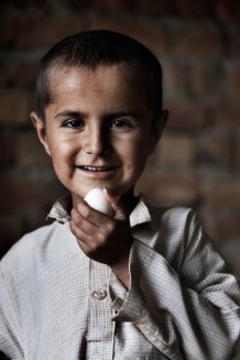 Interest Group, Assad, 6 years old, son of a beneficiary. Beneficiaries bring their products to the President, so her husband sells them to the market. Cesvi's project financed by Italian Development Cooperation. Malang Bargh, Nowshera District, KP. Pakistan, 2013