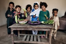 Children of beneficiaries showing their mothers' products. Cesvi's project financed by Italian Development Cooperation. Ajab Bargh, Nowshera District, KP. Pakistan, 2013