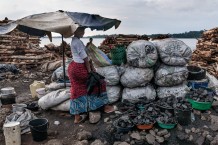 Aisha sells charcoal on the shore of Lake Victoria. Entebbe, Uganda, 2023