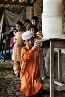 Shabir, 12 years old and friends using the water filter distributed by Iscos's project financed by Italian Development Cooperation. Banda Sheikh Ismail, Nowshera District, KP. Pakistan, 2013