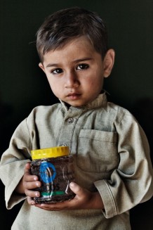 Pavad, 3 years old showing the honey produced thanks to the Iscos's distribution of beehives . Banda Sheikh Ismail, Nowshera District, KP. Pakistan, 2013