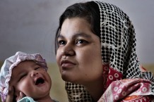 Shazadi Fatima Shabbir, 23 years old, posing for the Every Newborn Action Plan with her newborn girl, 15 days old, at her mother's house. After delivering, according to tradition, Pakistani women stay at their mothers' houses for 40 days. Taxila, Punjab. Pakistan 2014