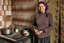 Maria, 83, deported from Poland during the Soviet era, is seen making tea in her kitchen during a home visit. Maria is very religious and lives with six cats. Prygozhe, population 160, Kharkiv Region, Ukraine, 2026