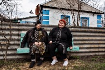 Tetiana, 54, a local community worker, stands outside her home, ready for house calls. She dreams only of the war ending, as it has brought physical, mental, and financial problems. She is very satisfied with her profession. Dmytrivka, Kharkiv Region, Ukraine, 2026