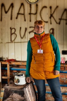 Margaryta, 48, a community worker, in a building occupied by the Russians, which is now used for community visits. Margaryta was born in the village, occupied in 2022 and liberated in 2023. She moved to a nearby village just two days before the occupation, and from there she saw her village in flames. Here, 40 of 400 houses remained intact; of 600 people, only 76 remain. Velyka Komyshuvakha, Kharkiv Region. Ukraine, 2026