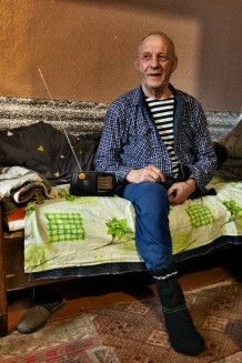 Anatoliy, 74, a retired miner and beneficiary, disabled (he had a leg amputated due to cancer and is visually impaired), during a home visit. Anatoliy and his wife, Nina, the same age, lived in Vuhledar in the Donetsk Region, where a major battle was fought, won by the Russians. They lost their home and a 15-year-old daughter and were displaced twice. Blyzniuky, Kharkiv Region. Ukraine, 2026
